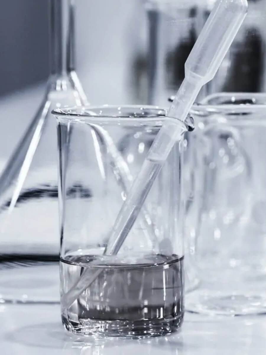 Glass beakers with clear liquid on a lab bench