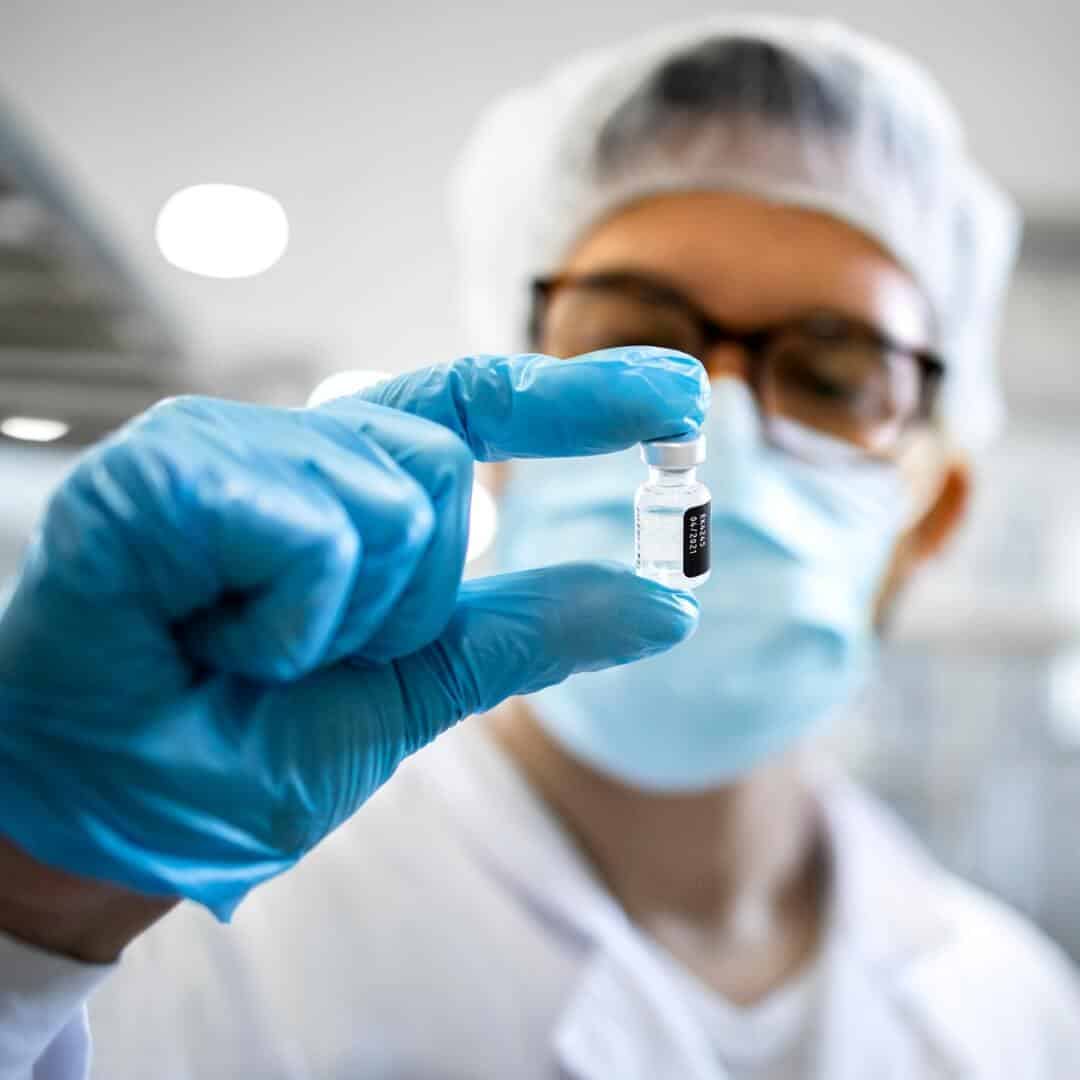 Scientist holding vaccine vial