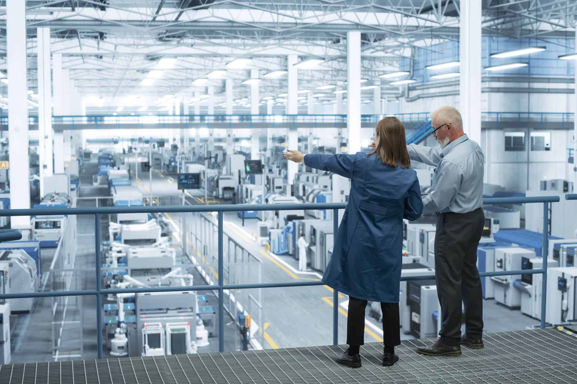Engineers overlooking factory floor
