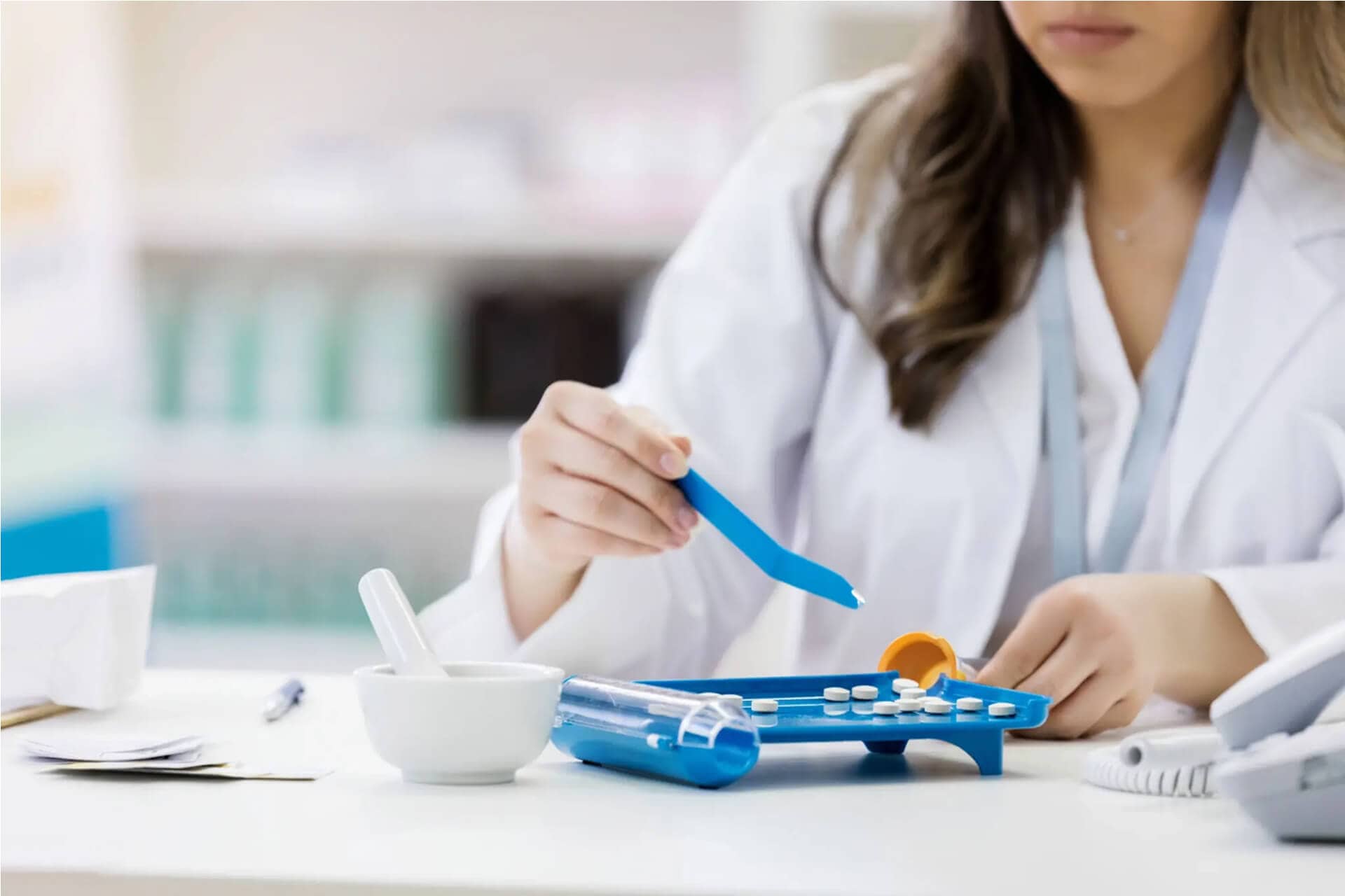 Pharmacist counting prescription pills