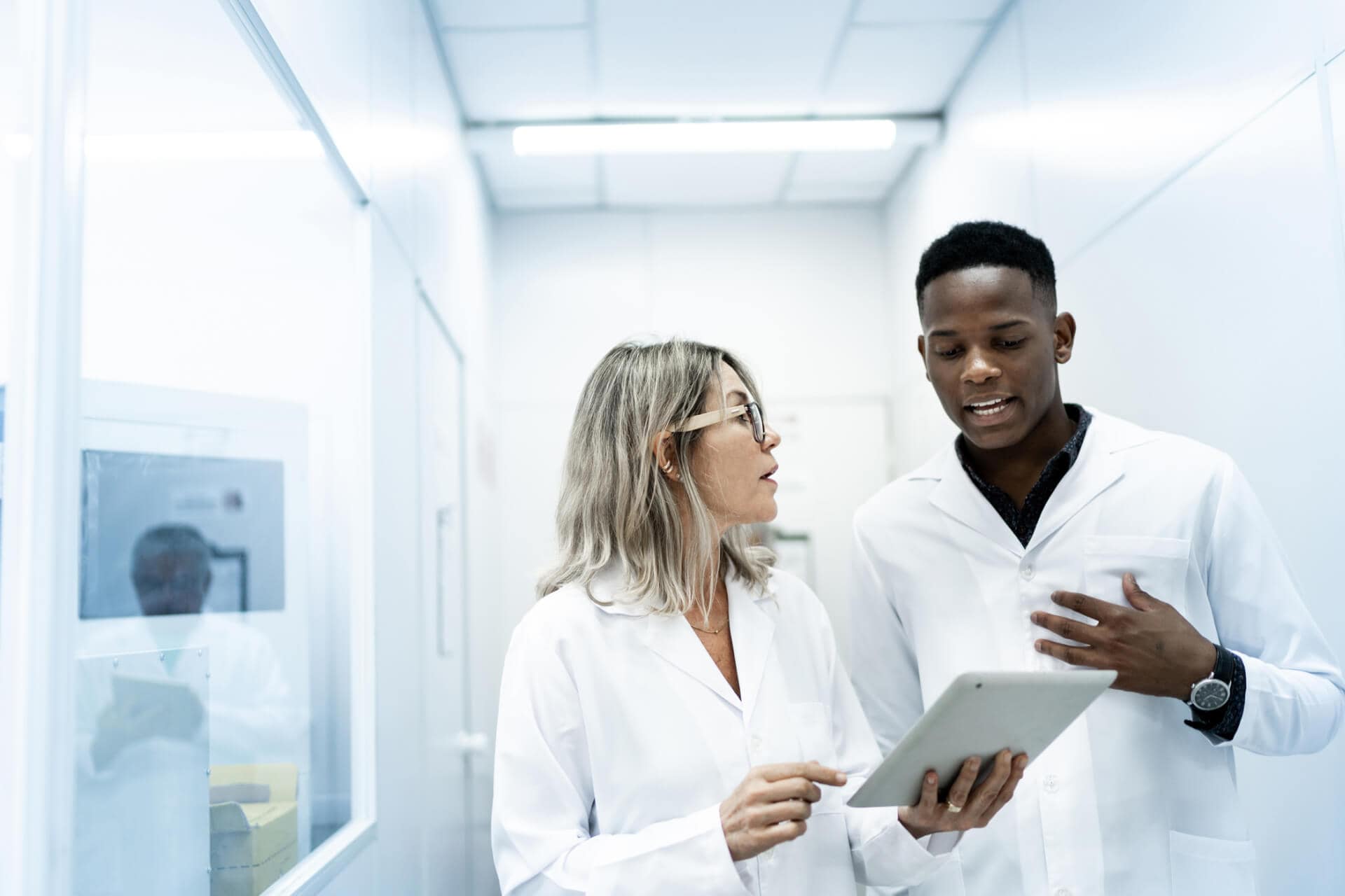 Researchers discussing data on tablet