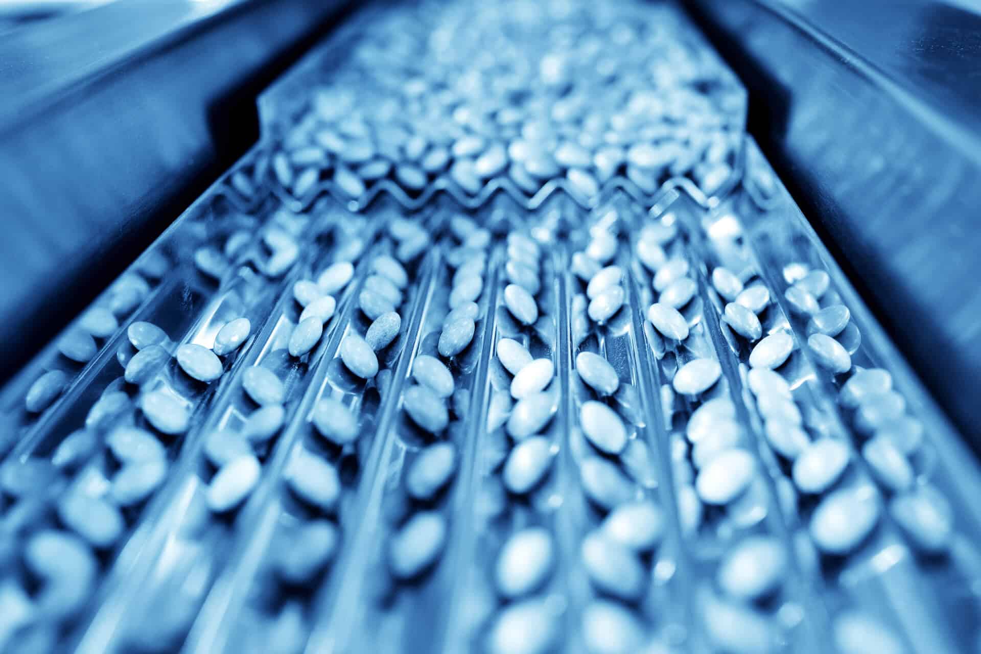 Pharmaceutical capsules on conveyor