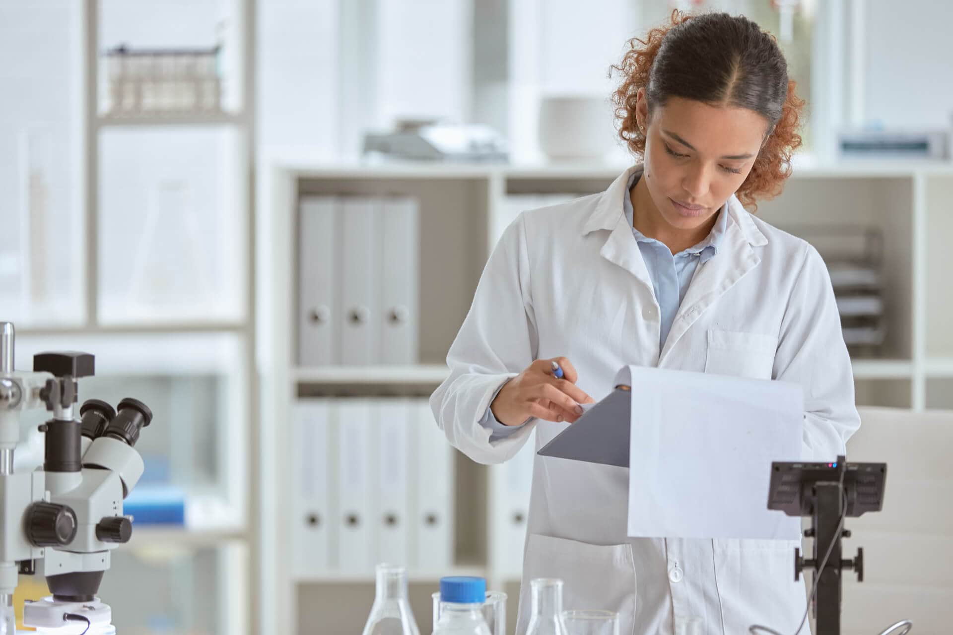 Scientist reviewing notes in lab